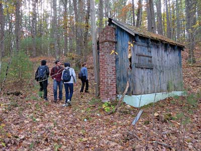 Group exploring old shack