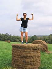 Laurie conquers a bale of hay